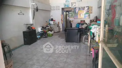 Spacious living room with tiled floor and eclectic decor, ideal for creative renovation.