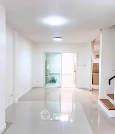 Spacious modern interior with glossy tiled floors and sliding glass doors, ideal for customization.