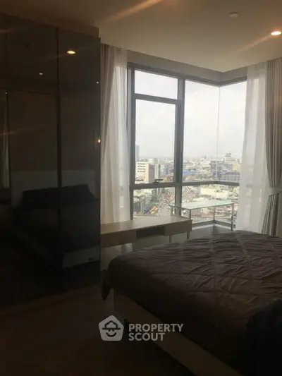 Modern bedroom with stunning city view and floor-to-ceiling windows