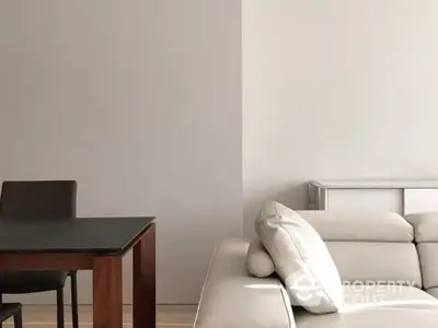 Elegant minimalist living room with a sleek white sofa and a dark wooden table, accentuated by soft natural lighting and neutral tones for a serene ambiance.