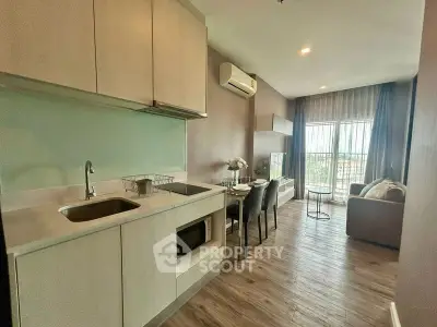 Modern open-layout kitchen and living room with large windows and stylish decor