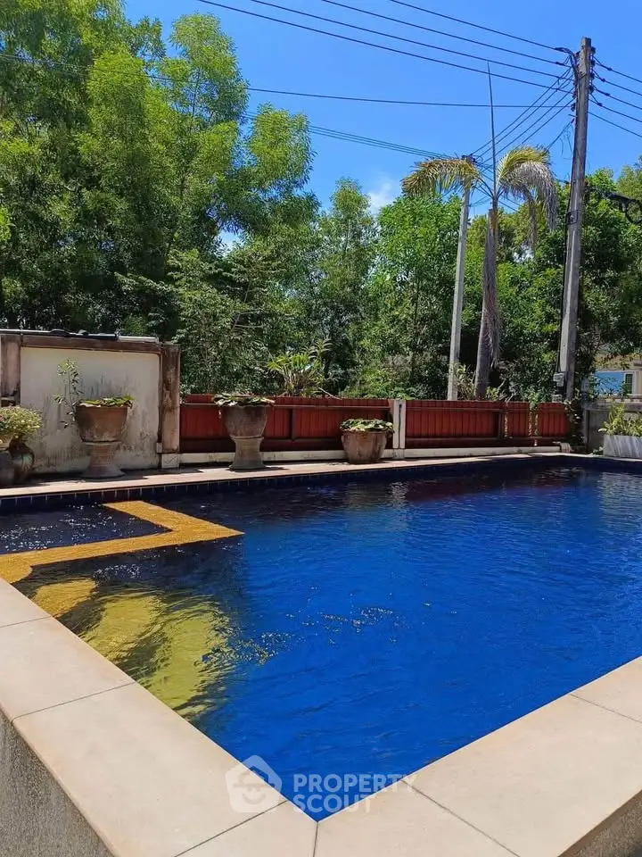 Luxurious private pool with lush greenery and serene ambiance.
