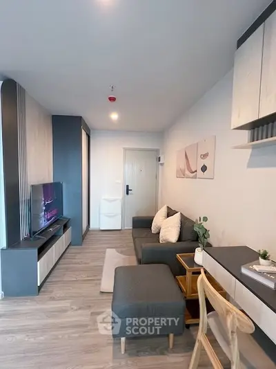 Modern living room with stylish decor and cozy seating area in a contemporary apartment.