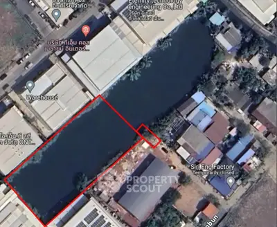Aerial view of industrial area with warehouses and factories, showcasing potential real estate investment.