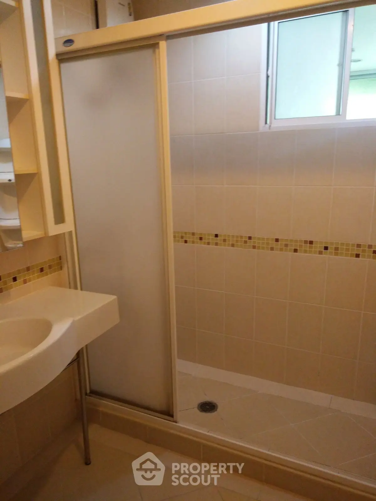 Modern bathroom with frosted glass shower door and stylish tile accents.