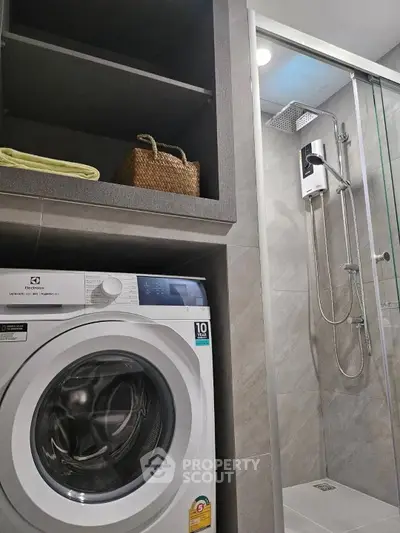 Modern bathroom with washing machine and glass shower enclosure