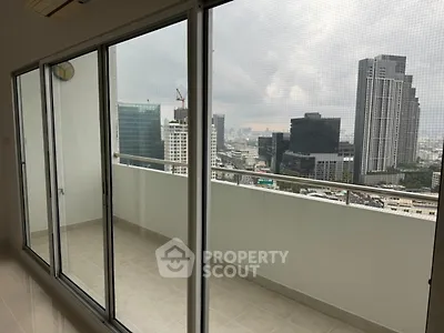 Spacious balcony with stunning city view from high-rise apartment