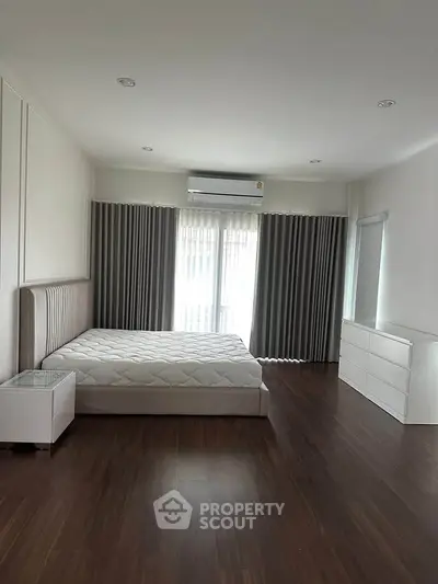 Spacious modern bedroom with elegant decor and natural light