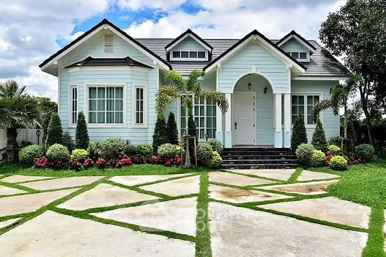 Charming single-story house with manicured garden and unique geometric driveway design.