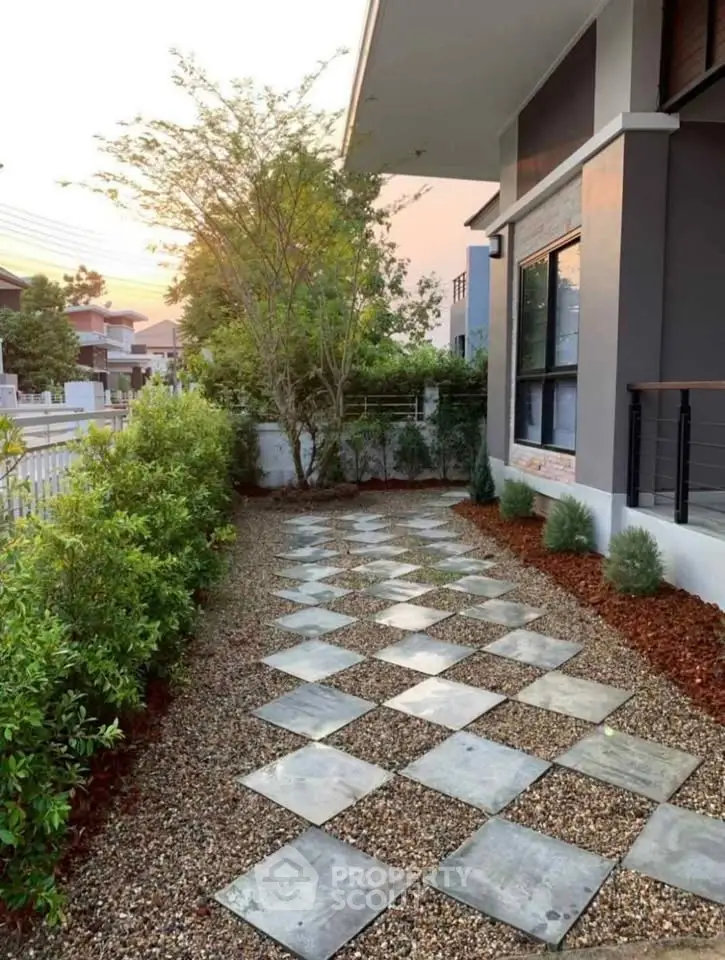 Charming modern home exterior with stylish walkway and lush greenery, perfect for serene outdoor living.