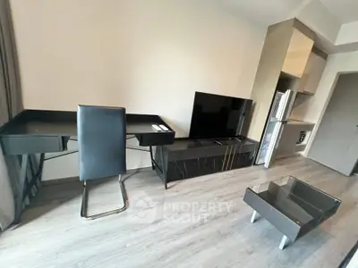 Modern living room with sleek furniture and open kitchen layout in a stylish apartment.