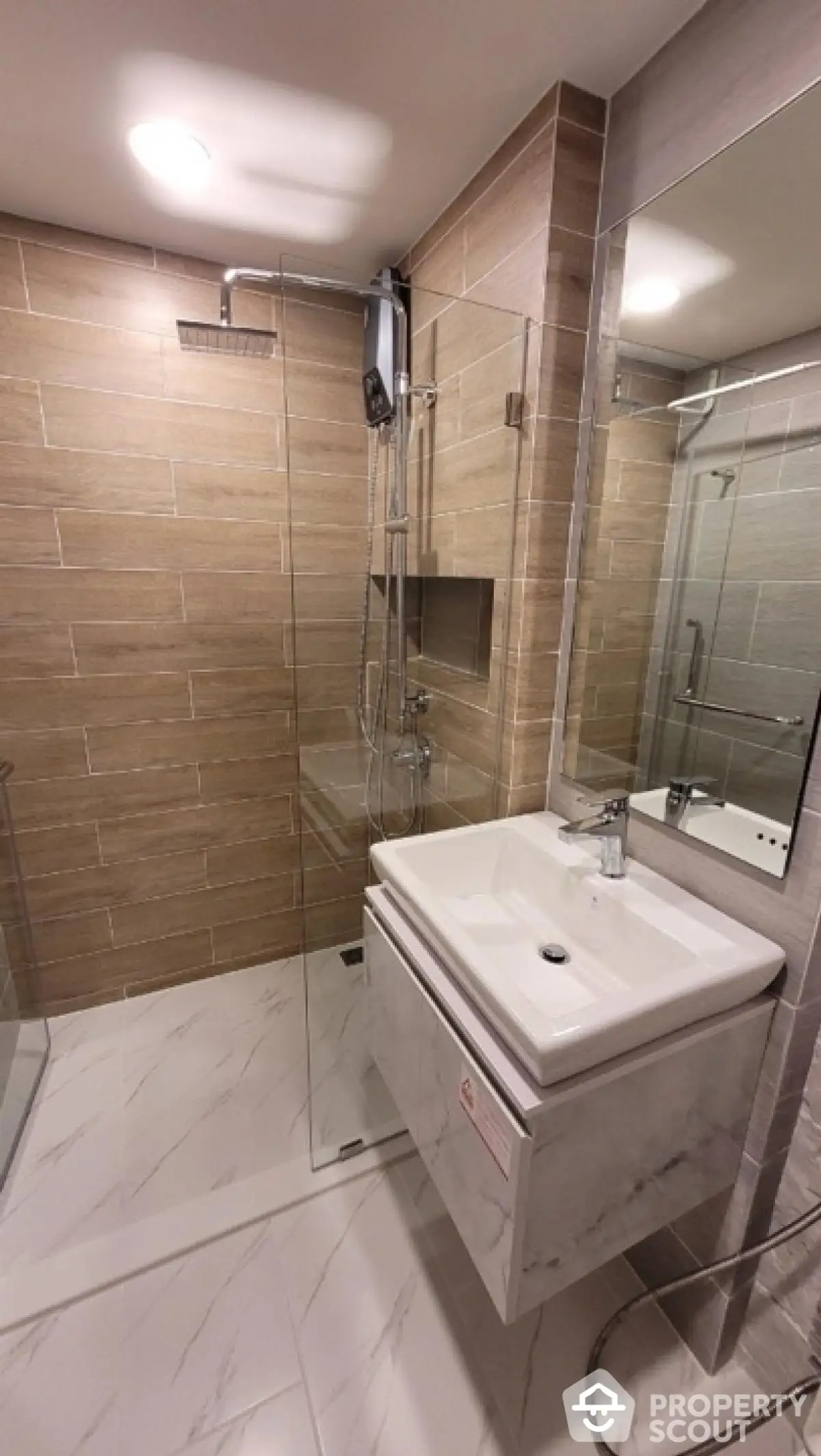 Modern bathroom with glass shower and sleek vanity in contemporary design.