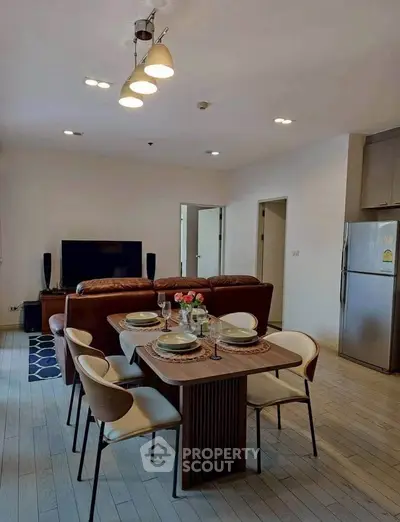 Modern living room with dining area and stylish furniture in open layout apartment.