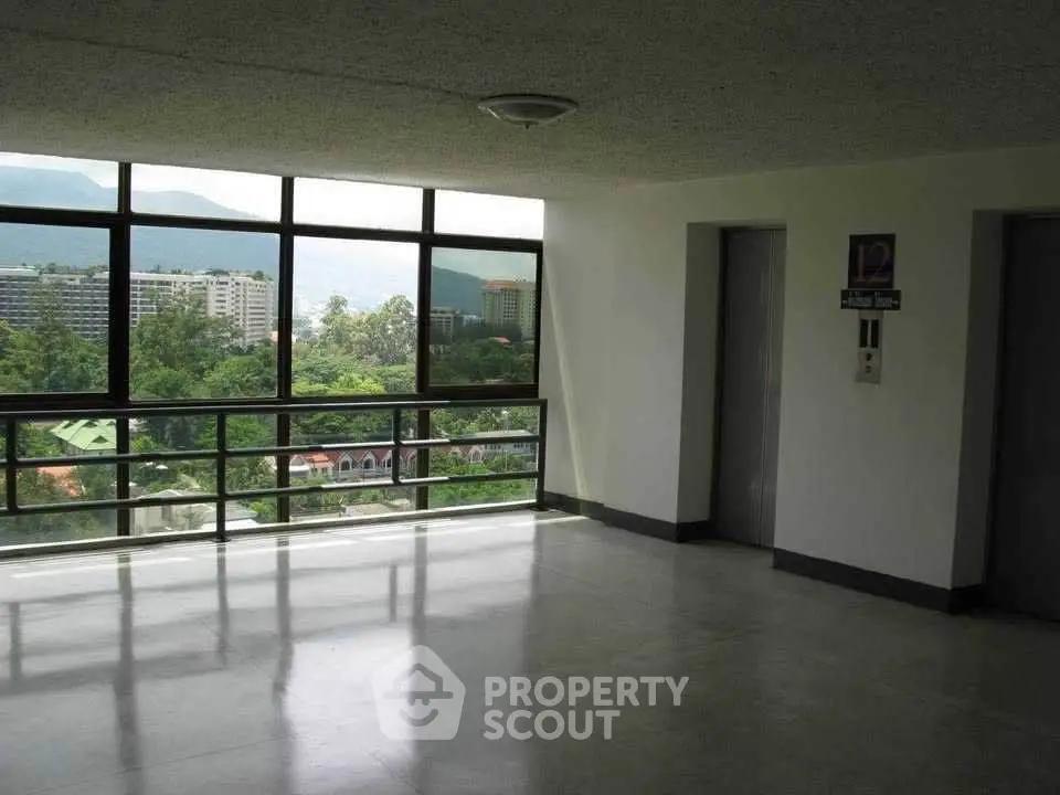 Spacious corridor with elevators and scenic view in modern building