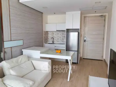 Modern open-layout kitchen with sleek appliances and cozy living area, perfect for urban living.