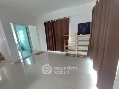 Spacious room with glossy floor and modern decor, ideal for versatile living space.