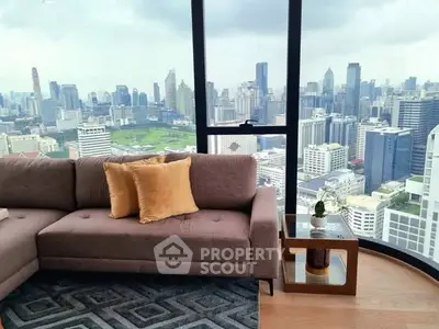 Luxurious living room with stunning city skyline view from high-rise apartment.