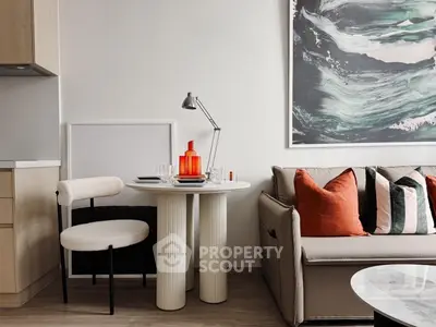 Modern living room with stylish decor, featuring a cozy sofa, chic table, and contemporary artwork.