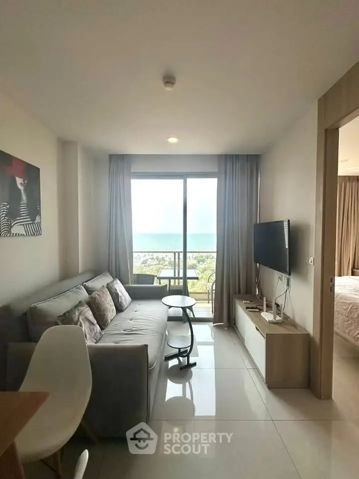 Modern living room with ocean view, stylish decor, and natural light