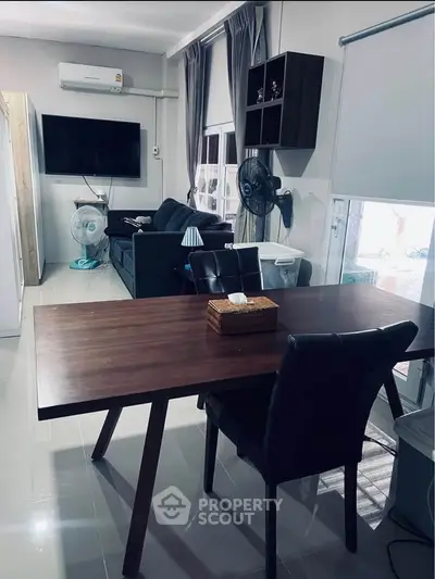Modern living room with sleek furniture and wall-mounted TV, perfect for contemporary living.