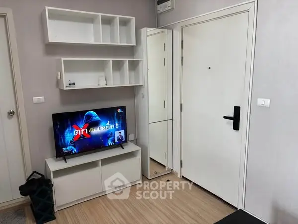 Modern living room with sleek TV setup and minimalist shelving