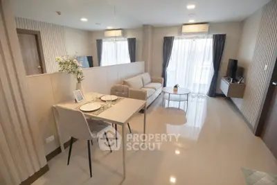 Modern living room with elegant decor and dining area in open layout apartment.