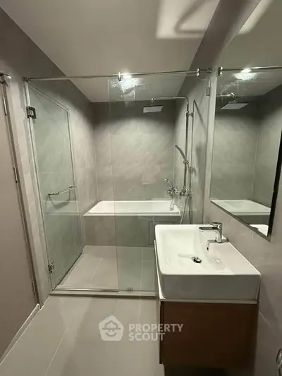 Modern bathroom with glass shower and sleek sink design