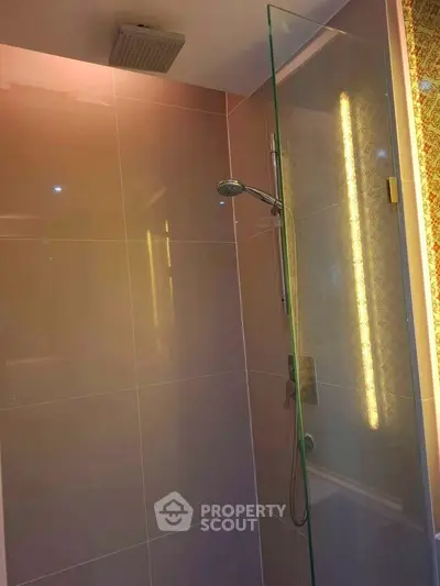Modern bathroom with glass shower and elegant lighting
