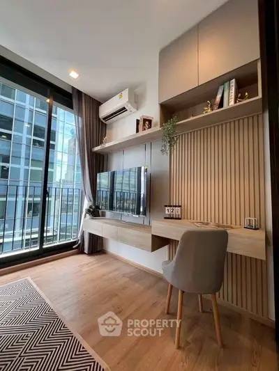 Modern study area with built-in desk and large window in urban apartment