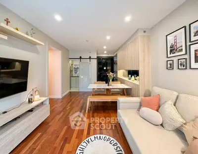 Modern living room with wooden flooring, cozy sofa, and stylish decor in a contemporary apartment.