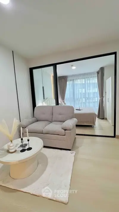 Modern living room with cozy sofa and elegant bedroom view
