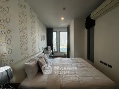 Cozy bedroom with modern decor and large window offering city view