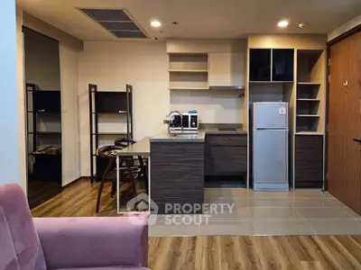 Modern kitchen with sleek cabinetry and stainless steel appliances in open layout