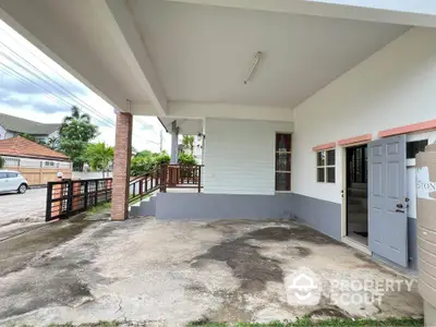 Spacious covered parking area with adjacent entrance in suburban home