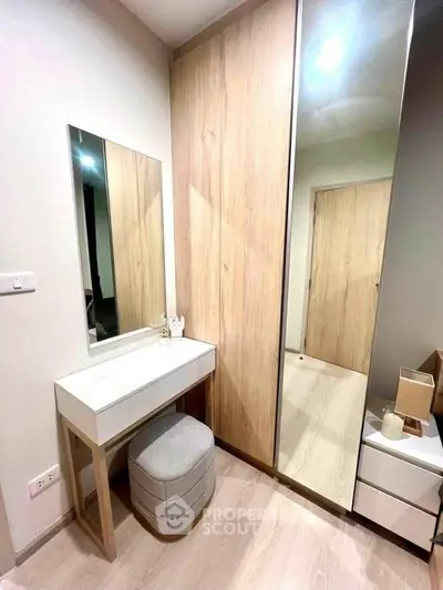 Modern bedroom with stylish vanity and mirrored wardrobe