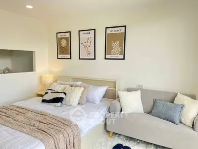 Cozy bedroom with modern decor and abstract art on walls