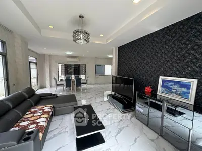 Luxurious modern living room with elegant decor and spacious layout, featuring a stylish chandelier and sleek furniture.