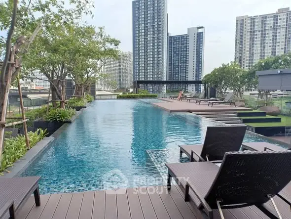 Luxurious rooftop pool with stunning cityscape views and modern lounge chairs.