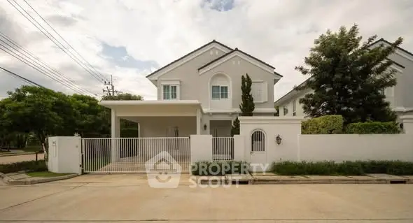 Elegant suburban house with spacious driveway and lush greenery, perfect for family living.