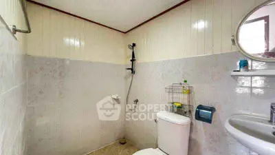 Compact bathroom with modern fixtures and neutral tiles