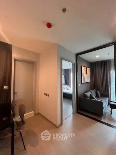 Modern apartment interior with cozy living room and bedroom, featuring stylish decor and natural lighting.