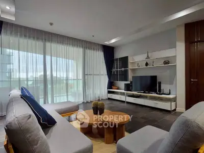 Spacious modern living room with large windows and stylish furniture