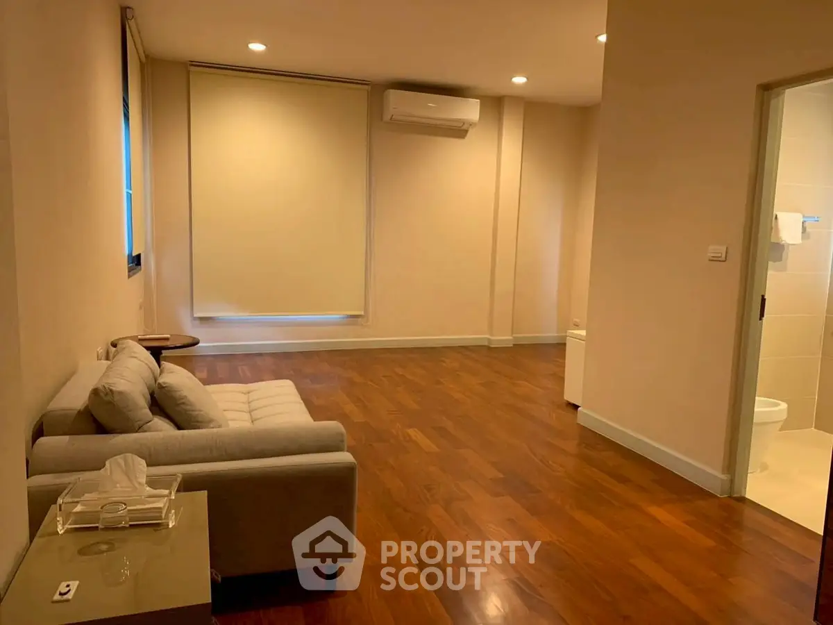 Spacious living room with wooden flooring and modern sofa