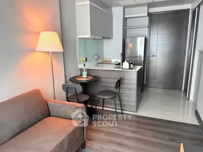 Modern studio apartment with cozy living area and compact kitchen, ideal for urban living.