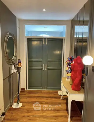 Stylish entrance with elegant double doors and decorative accents in modern home.