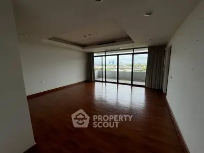 Spacious empty living room with large windows and city view
