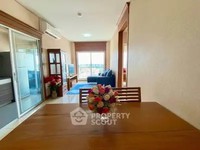 Spacious living room with modern decor and large window offering stunning views.