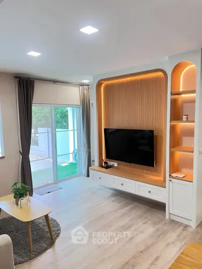 Modern living room with stylish TV setup and natural light