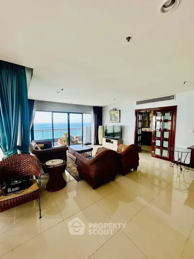 Spacious living room with ocean view and elegant wicker furniture