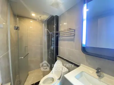 Modern bathroom with glass shower and sleek fixtures